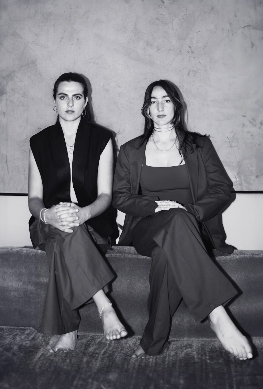 Justine Vilgrain and Patricia Gloum seated side by side, black and white portrait